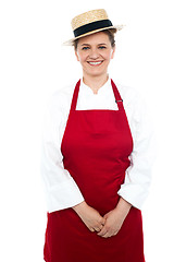 Image showing Smiling middle aged female chef wearing hat