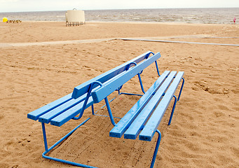 Image showing Blue bench and bathing-box on seaside beach sand 