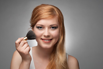 Image showing Girl does a make-up