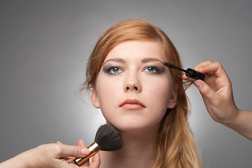 Image showing Girl does a make-up