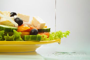 Image showing Greek Salad with oil flowing