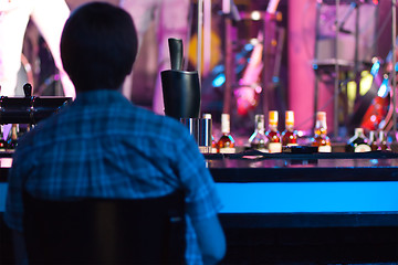 Image showing Man sitting in a bar