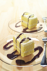 Image showing fresh cream cake closeup with chocolate sauce