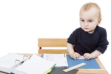 Image showing young child at writing desk