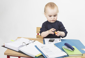 Image showing young child at writing desk