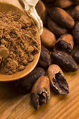 Image showing Cocoa (cacao) beans on natural wooden table