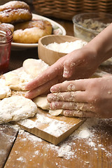 Image showing Detail of hands kneading dough