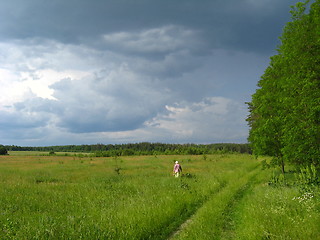 Image showing a woman going on the green grass