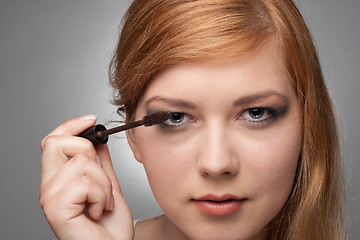 Image showing Girl does a make-up