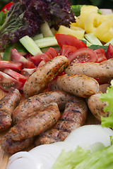 Image showing grilled sausage, fresh herbs, tomatoes, onions