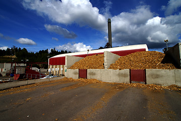 Image showing bio power plant with storage of wooden fuel against blue sky