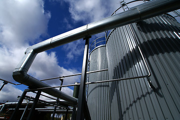 Image showing industrial pipelines and tanks with a natural blue background