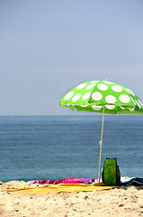 Image showing Funny green sun ubrella on the beach