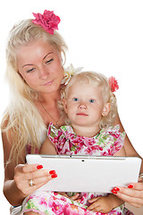 Image showing mother and daughter looking tablet, isolated on white