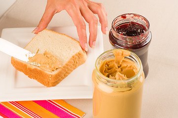 Image showing Spreading peanut butter
