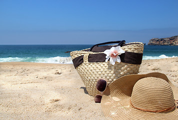 Image showing Seacoast, straw beach bag, hat and sunglasses 