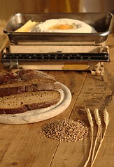 Image showing Wheat with bread, eggs, flour and old kitchen scales