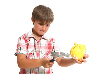 Image showing boy with a hammer breaking a piggybank against white background