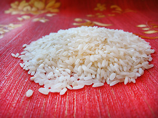 Image showing scattered rice on a red background