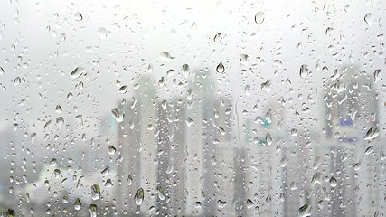 Image showing rain drops on glass with city background