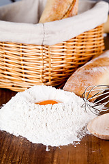 Image showing read, flour, eggs and kitchen utensil