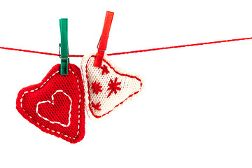 Image showing two knitted hearts on a red string