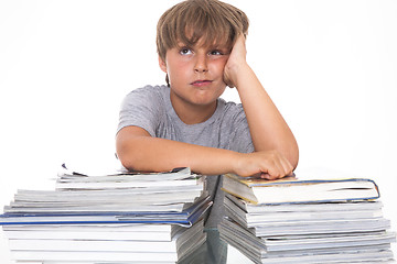 Image showing Portrait of a stressed young student with a pile of books to rea