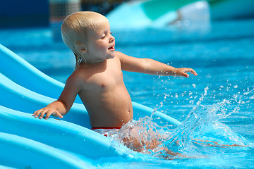 Image showing Child on water slide at aquapark.