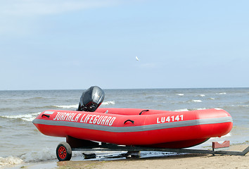 Image showing Rubber lifeguard boat trailer on sea shore 