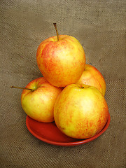 Image showing four apple on the brown background