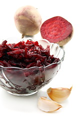 Image showing Beet salad with garlic in glass salad bowl.