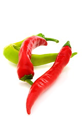 Image showing Two red and one green pepper.