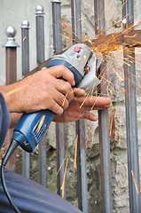 Image showing Worker hands with grinder