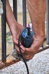 Image showing Worker hands with grinder