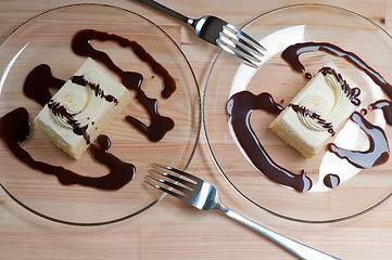 Image showing fresh cream cake closeup with chocolate sauce