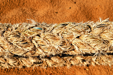 Image showing thick synthetic rope and sea sand on background 