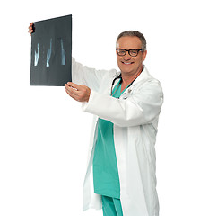 Image showing Smiling doctor in glasses reviewing x-ray report