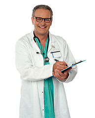 Image showing Experienced male doctor making report