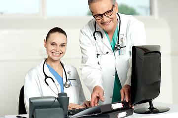 Image showing Team of doctors working on computer