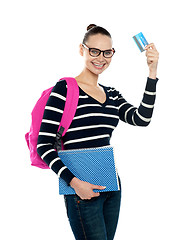 Image showing Teenager showing credit card to camera