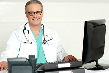 Image showing Aged physician with stethoscope around his neck