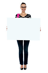 Image showing College girl holding white ad board, full length shot