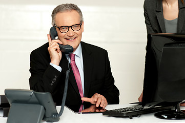 Image showing Aged businessman communicating on phone