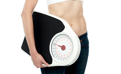 Image showing Closeup shot, woman carrying weighing machine