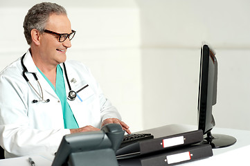 Image showing Experienced doctor working on computer