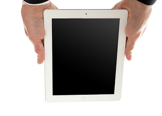 Image showing Man holding tablet device upside down