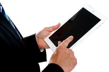 Image showing Man operating touch screen device, focus on tablet