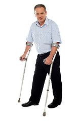 Image showing Old handicapped man with a walker