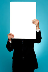 Image showing Manager hiding his face behind white banner ad