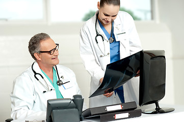 Image showing Team of two doctors reviewing x-ray report